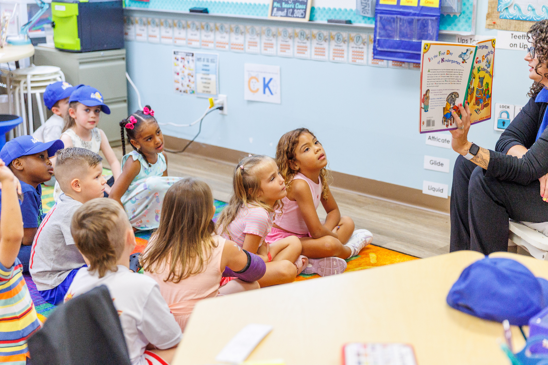Sunlight teacher engaging with two students in a preschool classroom